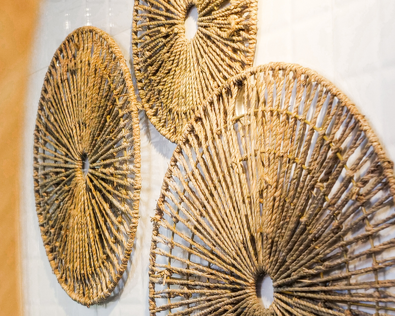 Golden Jute Rays decorative wall art, showcasing handcrafted jute circles for a natural, earthy aesthetic.