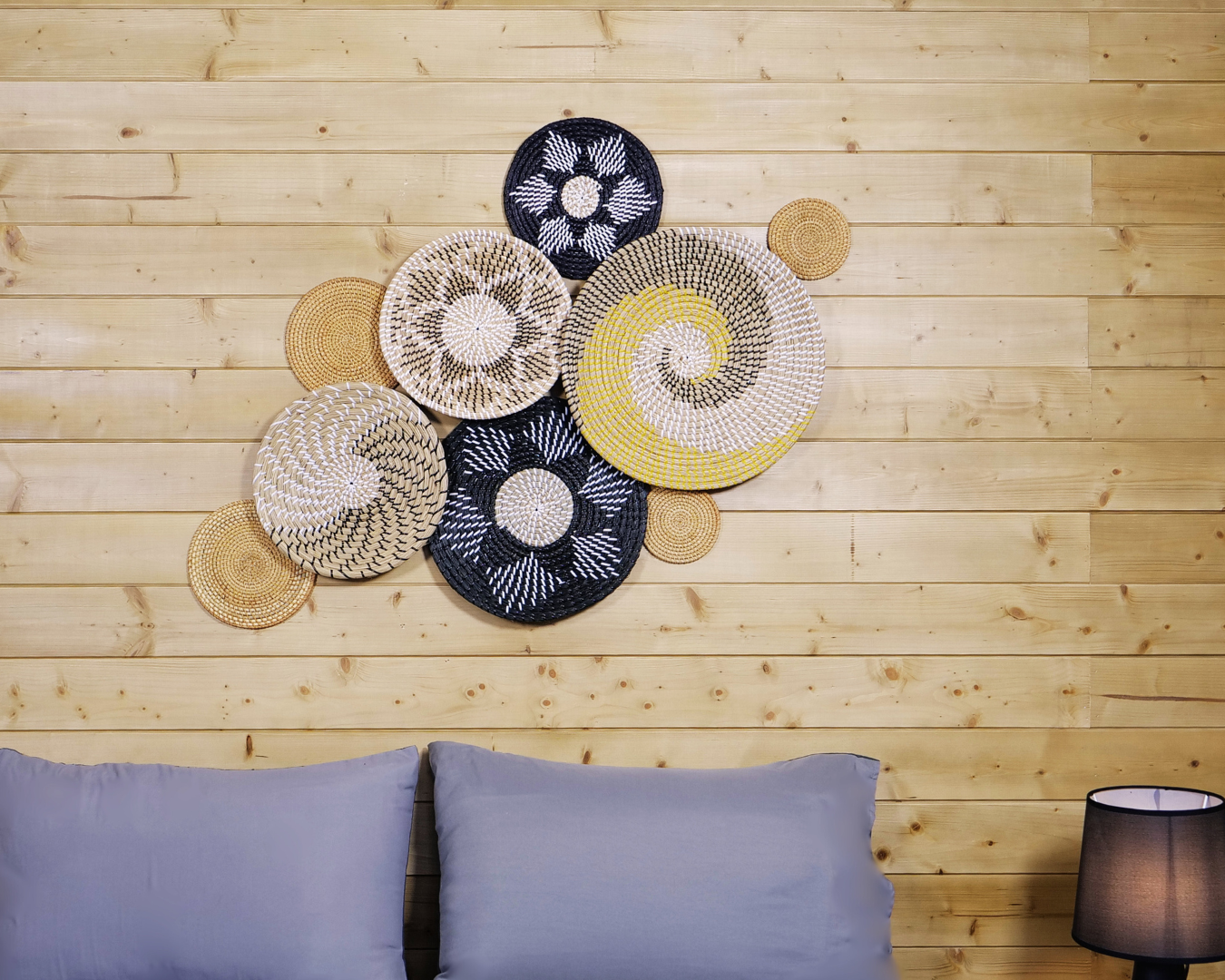Sunburst Fusion wall decor displayed on a wooden backdrop above a cozy bed setup.