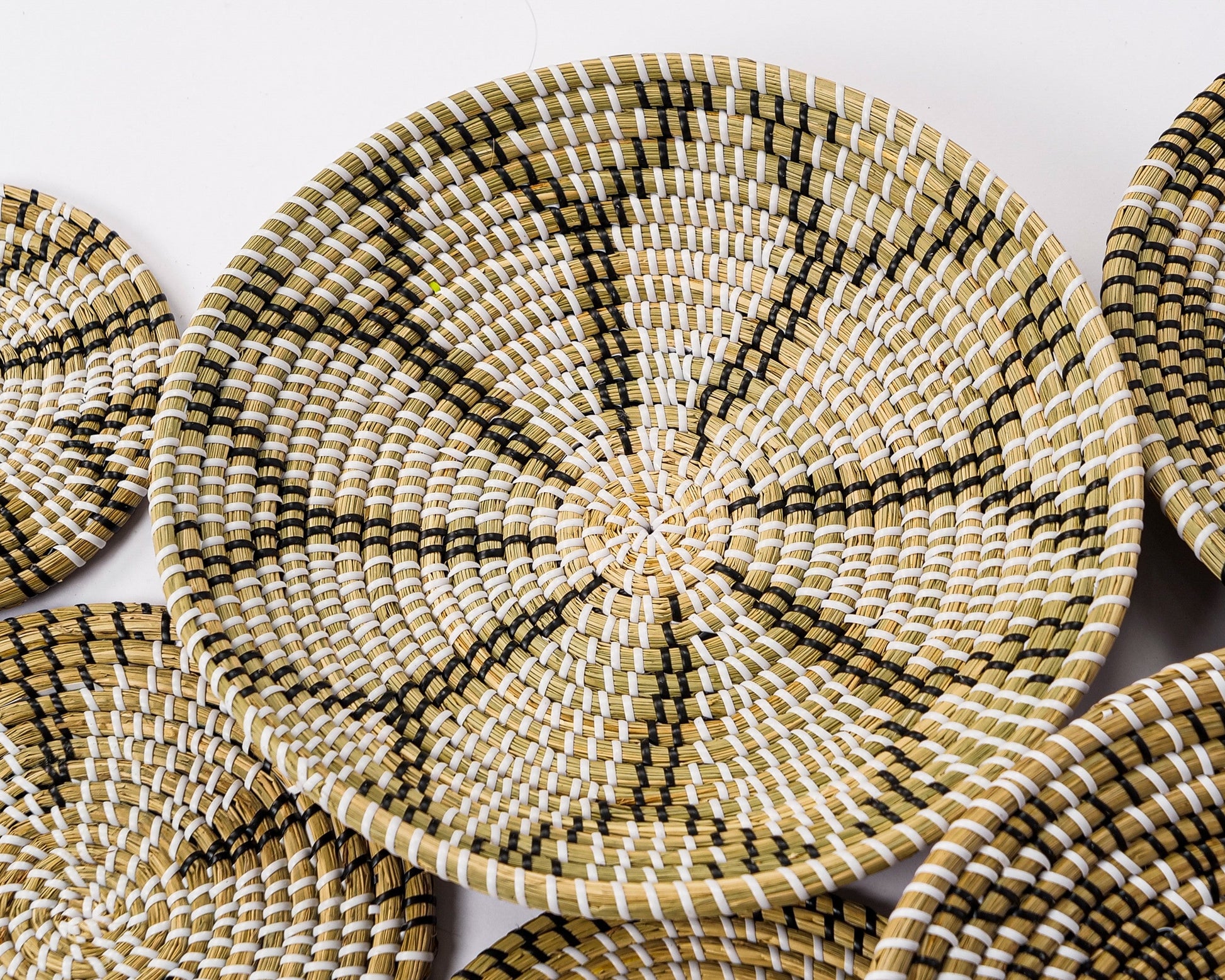 Close-up of Tribal Weaves handcrafted seagrass baskets featuring intricate woven patterns, perfect for boho wall décor and natural home styling.